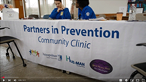 A table with a banner reading partners in prevention community clinic