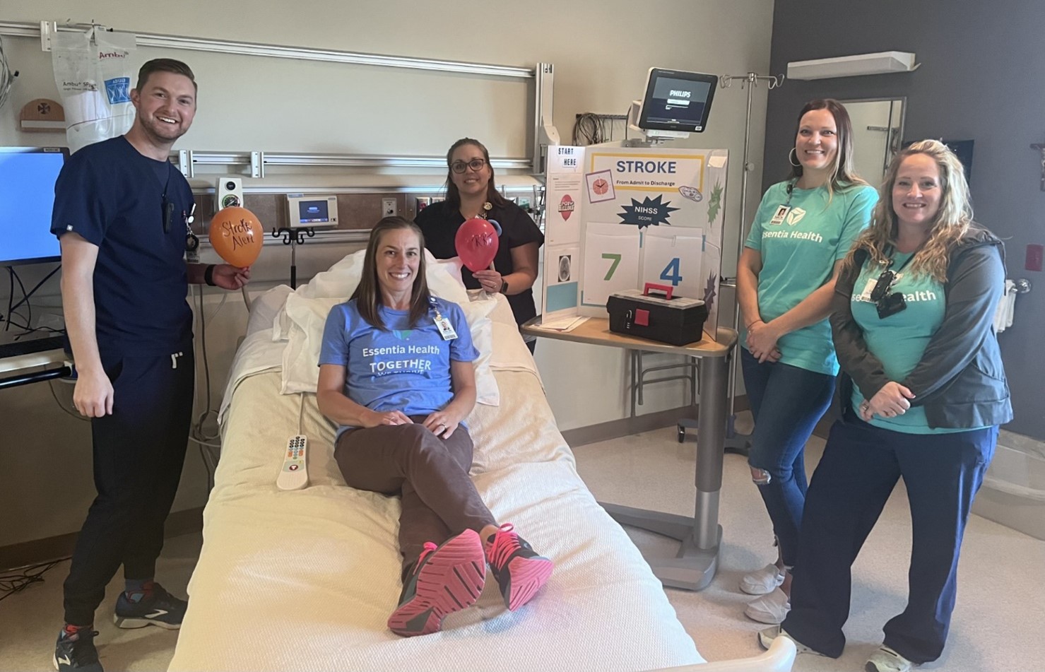 health care workers stand in a hospital room