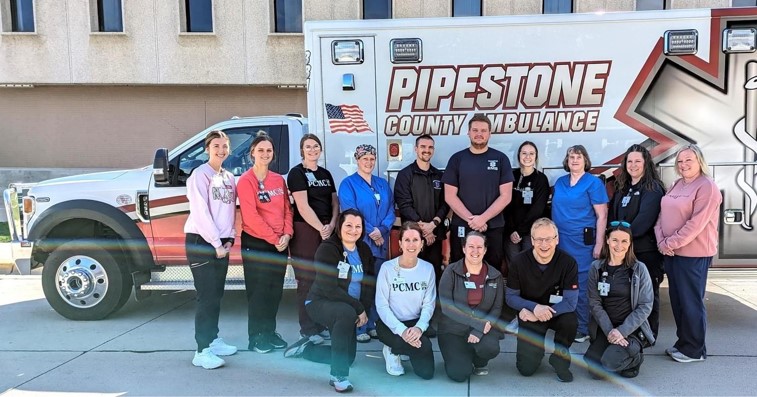 health care workers in front of ambulance