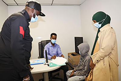 Woman and child getting help with paperwork.