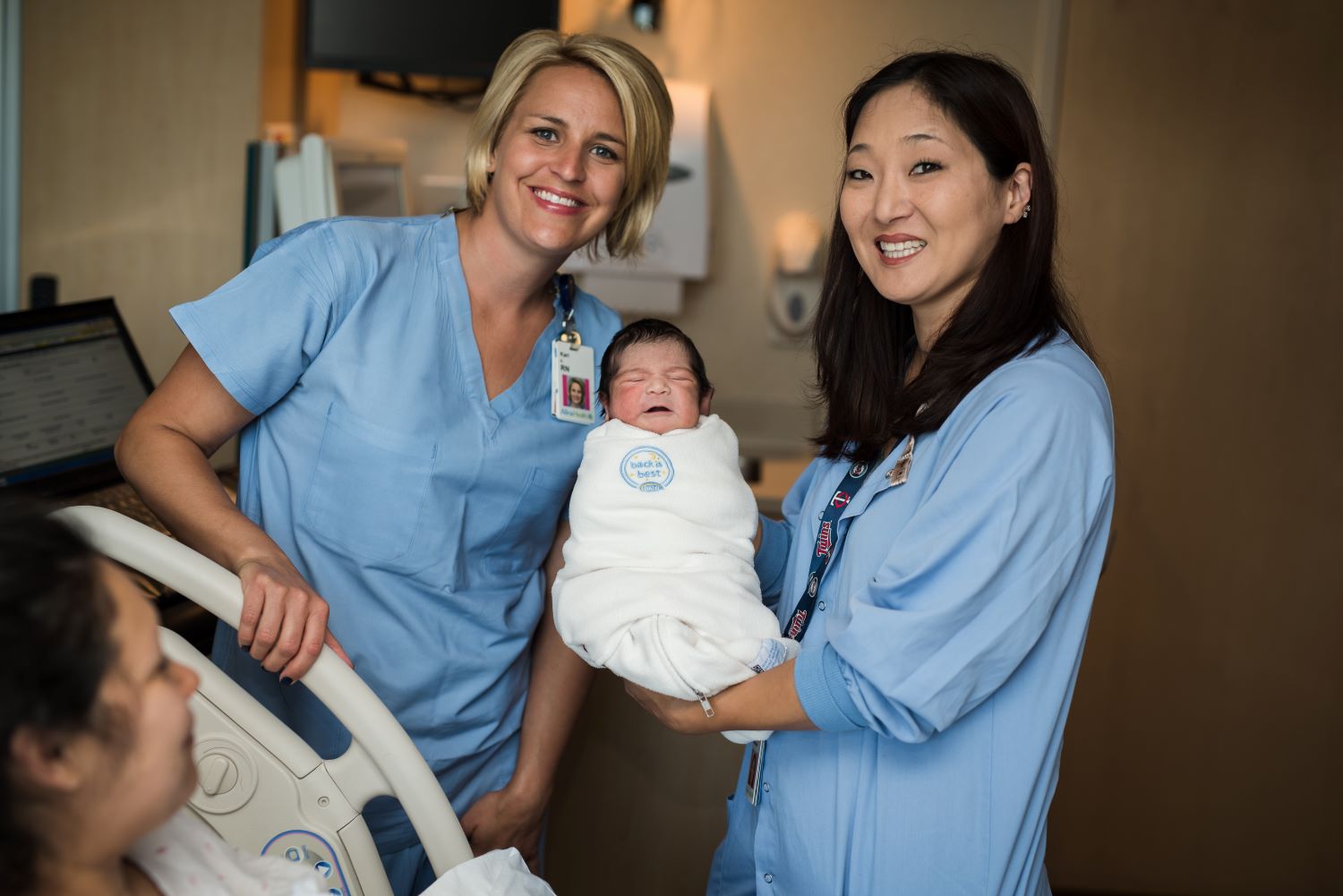 Newborn baby with nurses
