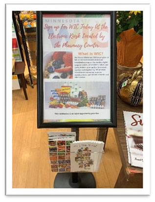 Small standing bulletin board with information and WIC pamphlets in a grocery store.