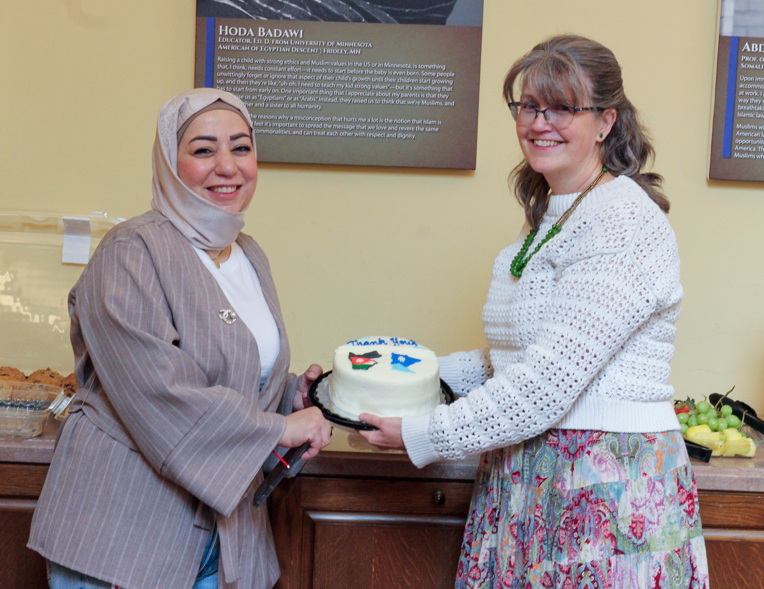 Anna Strain and Jordanian scientist with cake