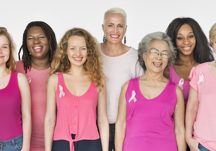 Group of women wearing pink and breast cancer ribbons